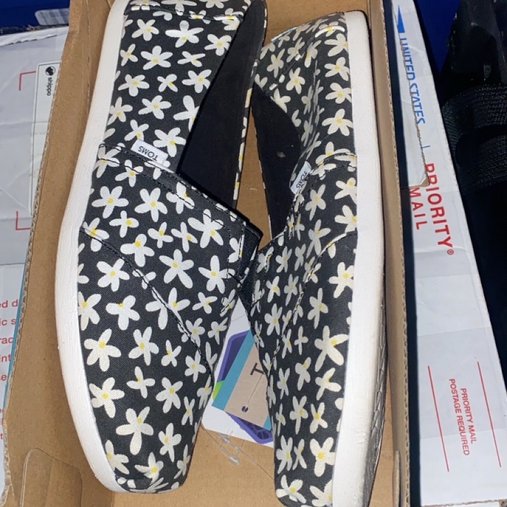 Toms Black and White Daisy Slip-Ons